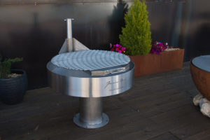 a round grill on a deck