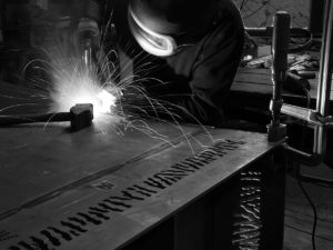 Damien Rais soudant un brasero artisanal à Glovelier Suisse